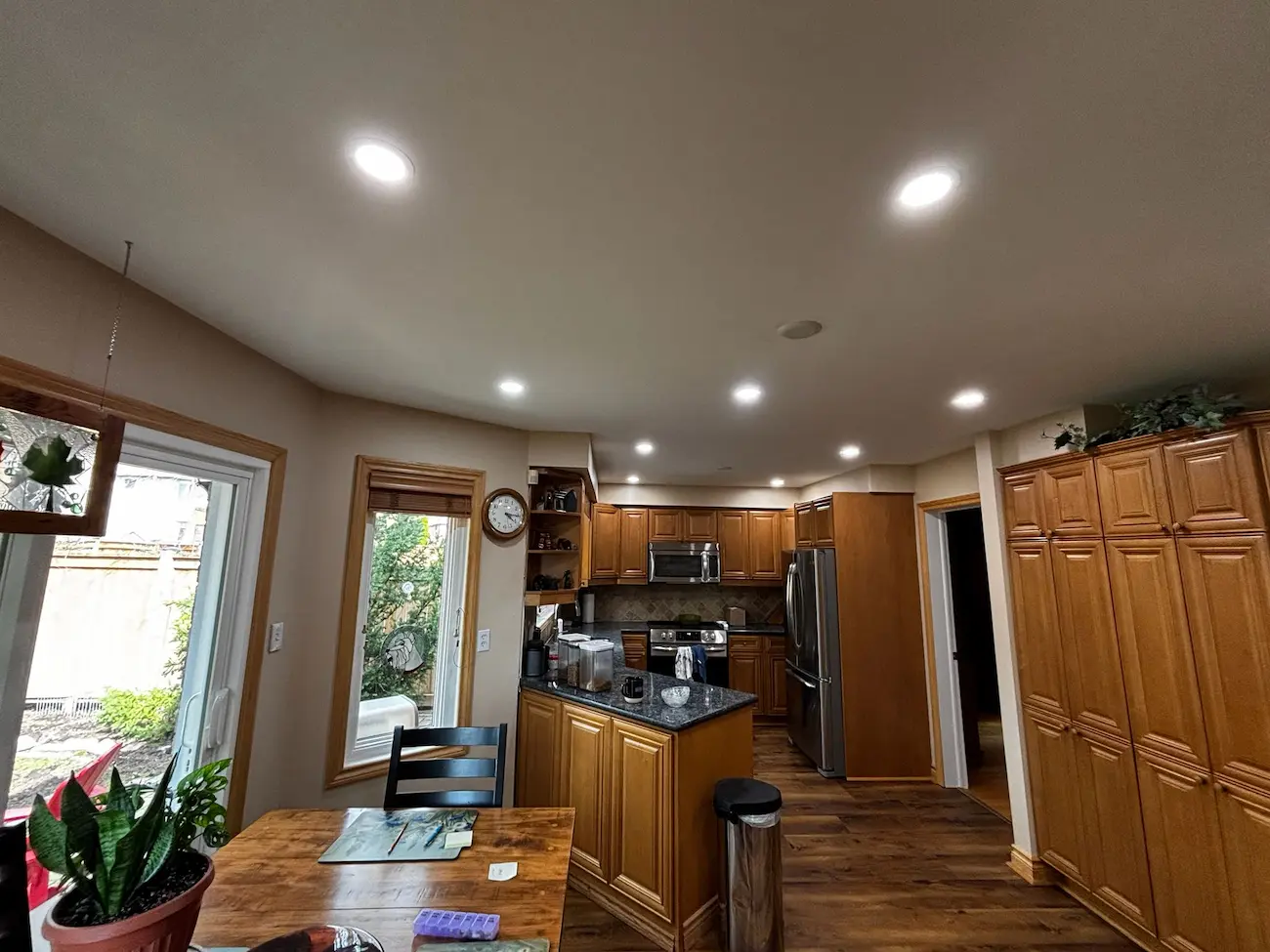 Kitchen recessed lighting layout in an older home with evenly spaced pot lights